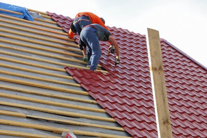 Professional roofing team installing and maintaining a roof