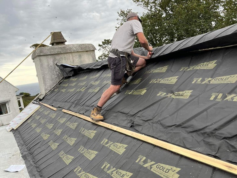 Professional Ironclad Roofs team repairing a damaged roof